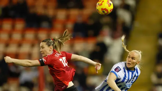 Manchester United women's Elisabeth Terland (left) and Brighton and Hove Albion Women's Maria Thorisdottir (right) challenge during the Barclays Women's Super League match at Leigh Sports Village.