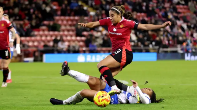 Gabby George of Manchester United is challenged by Madison Haley of Brighton & Hove Albion during the Barclays Women's Super League match between Manchester United and Brighton & Hove Albion