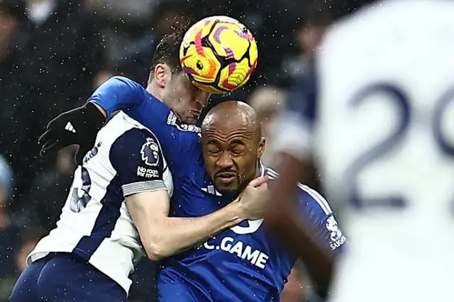 Ben Davies (L) fights for the ball with Jordan Ayew