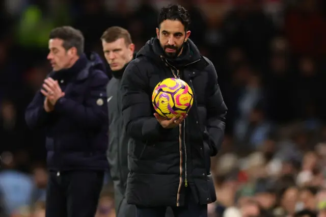 Manchester United Manager Ruben Amorim holds the match ball.