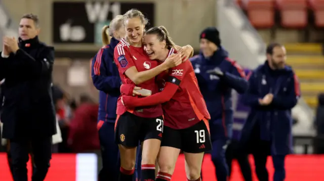 Elisabeth Terland of Manchester United celebrates victory with teammate Millie Turner during the Barclays Women's Super League match between Manchester United and Brighton & Hove Albion at Leigh Sports Village