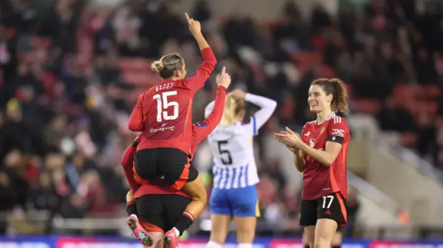 Celin Bizet Ildhusoy of Manchester United celebrates scoring her team's third goal with teammates during the Barclays Women's Super League match between Manchester United and Brighton & Hove Albion at Leigh Sports Village