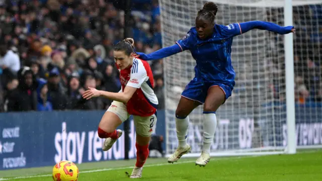 Emily Fox of Arsenal is challenged by Sandy Baltimore of Chelsea during the Barclays Women's Super League match between Chelsea FC and Arsenal FC