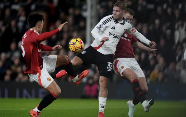 Fulham's Emile Smith Rowe (centre) and Manchester United's Lisandro Martinez (left) and Matthijs de Ligt (right) battle for the ball