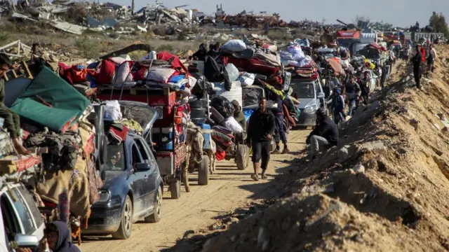 Palestinians, displaced to the south at Israel's order during the war, wait to have their vehicles inspected by the Egyptian-Qatari committee as they return to their homes in northern Gaza