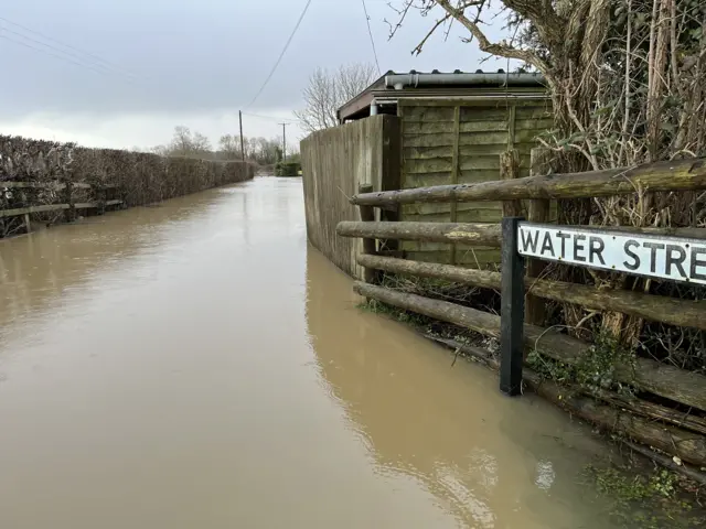 A rural street submerged in flood water