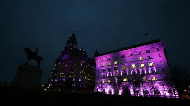 A view shows the Royal Liver Building, and the Cunard building, illuminated purple to honour the victims of the holocaust, in Liverpool,