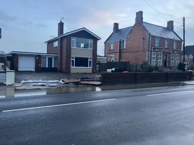 A house with sandbags and flood defences outside