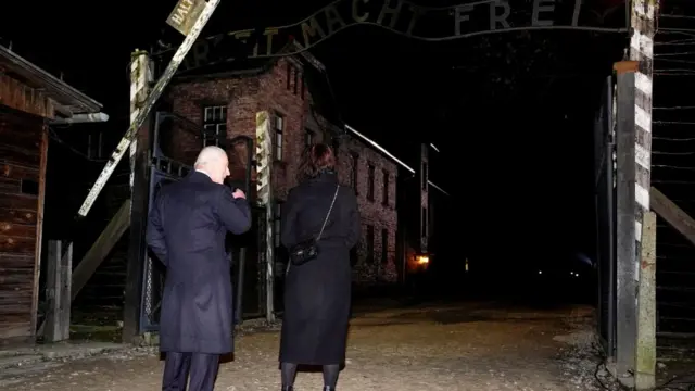 Charles walks through the gates to Auschwitz