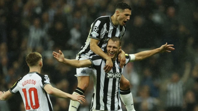 Newcastle United's Dan Burn celebrates scoring their second goal with Fabian Schar