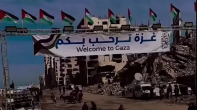 A banner saying Welcome to Gaza in the Wahsh district near Gaza City, with rubble in the background