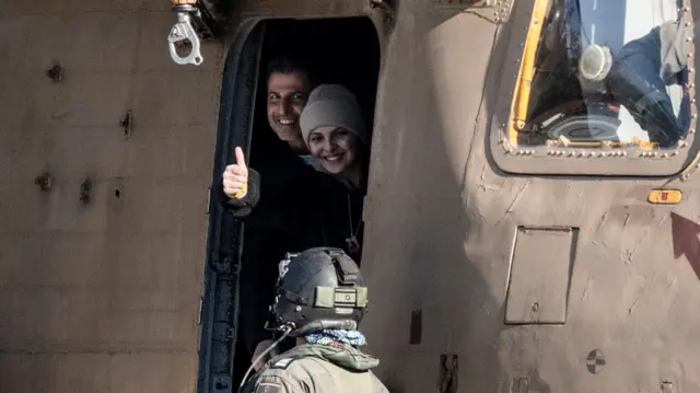 Released Israeli hostage, Daniella Gilboa, with her thumb up outside of an Israeli plane