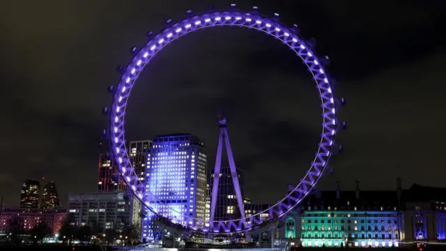 The London Eye is lit up in purple light during International Holocaust Remembrance Day