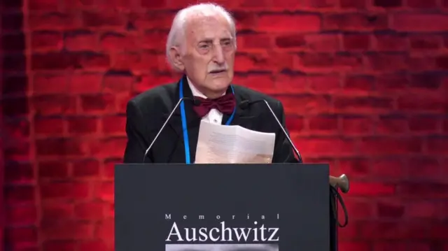 Weintraub, an old man, speaks at the event