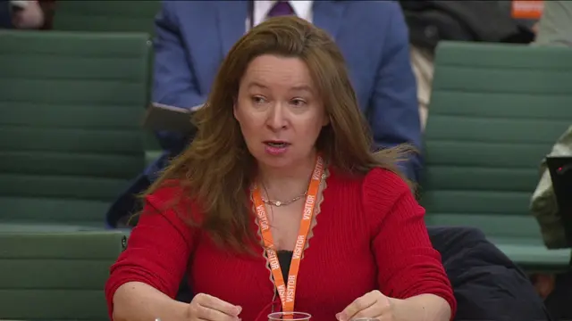 Dr Rachel Clarke, wearing a red top, speaks to MPs