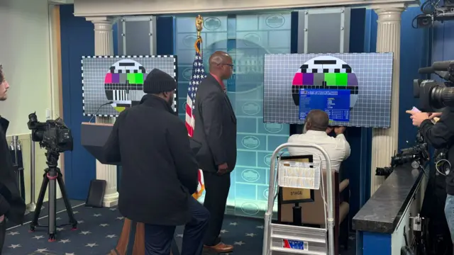 Screens being set up in the White House briefing room