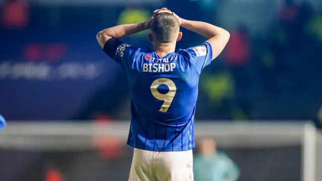 Colby Bishop reacting during Portsmouth's loss to West Bromwich Albion