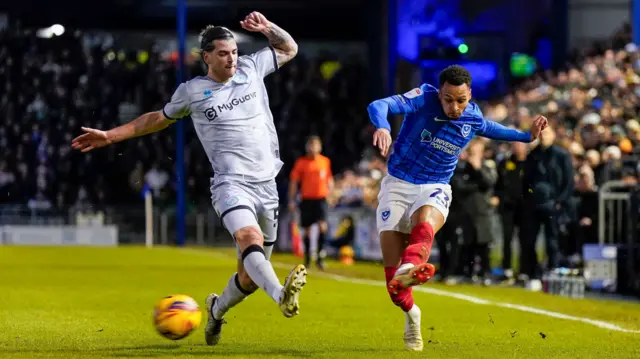 Josh Murphy sends in a cross under pressure from Millwall defender Tristan Crama