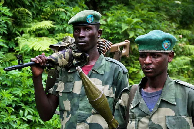 wo March 23 Movement (M23) rebel soldiers walk at an M23 rebel-held position on Kavumu hill in North Kivu, eastern Democratic Republic of the Congo (DRC), on June 3, 2012