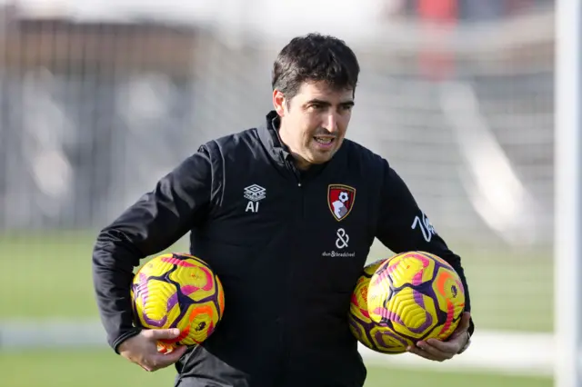 Andoni Iraola holds footballs under his arms