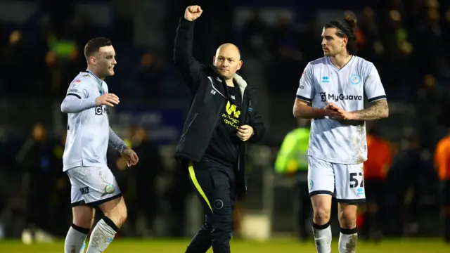 Victorious Millwall manager Alex Neil raises a fist in celebration