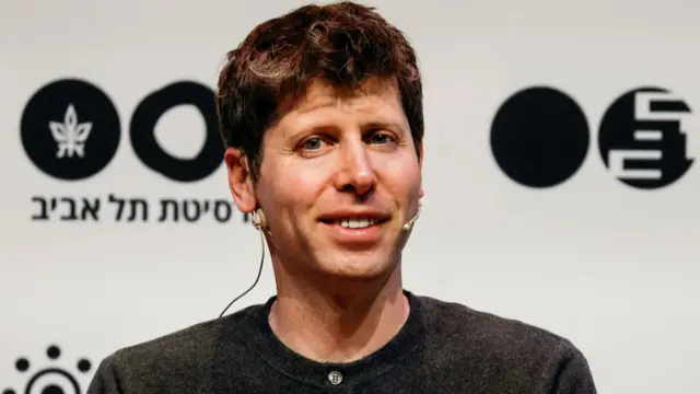 Sam Altman wearing a grey sweatshirt