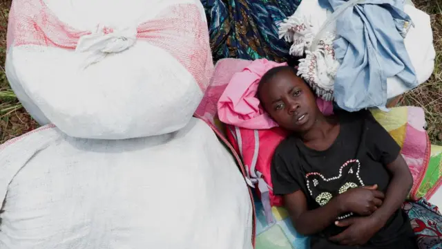 Congolese child looks on after fleeing from Goma, eastern Democratic Republic of Congo following fighting between M23 rebels and the Armed Forces of the Democratic Republic of the Congo (FARDC), at a reception centre in Rugerero near Gisenyi, in Rubavu district, Rwanda, January 28, 2025