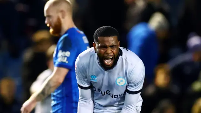 Millwall defender Japhet Tanganga screams in celebration at full-time