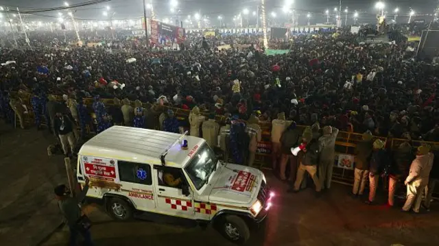 Police personnel gather around the crowd at the site of stampede amid the ongoing Maha Kumbh Mela festival in Prayagraj