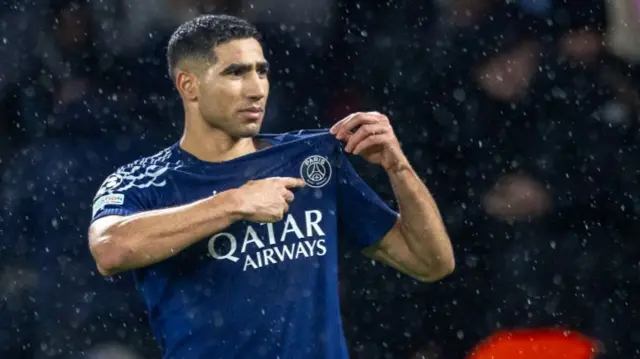 Achraf Hakimi points to the PSG badge after victory over Man City