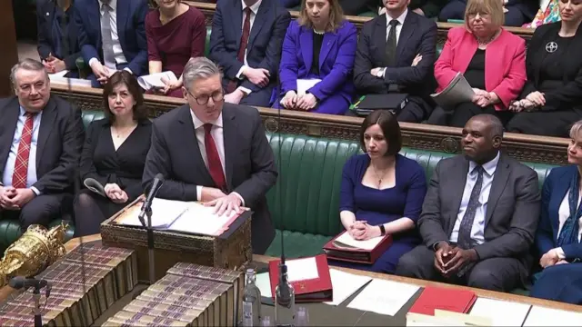 Starmer leans on the dispatch box in the House of Commons
