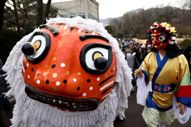 South Korean performers wearing traditional clothes participate in a traditional event