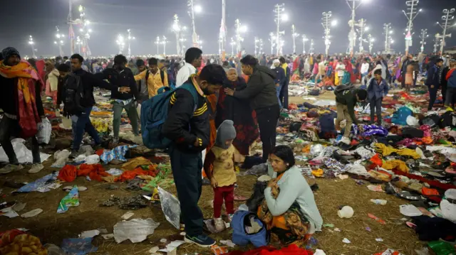 Devotees stand after a crush at the Kumbh Mela in Prayagraj