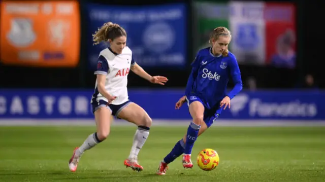 Katja Snoeijs of Everton runs with the ball whilst under pressure from Luana Buhler of Tottenham Hotspur during The Adobe Women's FA Cup Fourth Round match between Everton and Tottenham Hotspur