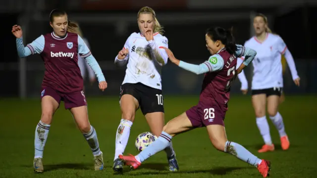 ophie Roman Haug of Liverpool is challenged by Li Mengwen of West Ham during The Adobe Women's FA Cup Fourth Round match between West Ham United and Liverpool