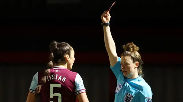 Match Referee Kirsty Dowle shows a red card to Amber Tysiak of West Ham United during The Adobe Women's FA Cup Fourth Round match between West Ham United and Liverpool