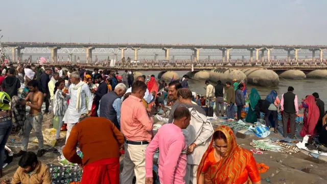 Religious worshippers dressed in colourful saris and shirts gather on the banks of the Ganges River to take part in a holy dip.