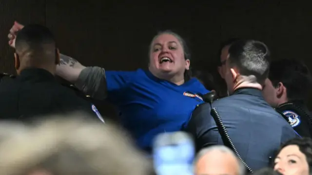 US Capitol Police officers remove a protestor as Secretary of Health and Human Services nominee Robert F. Kennedy Jr. testifies during a Senate Finance Committe