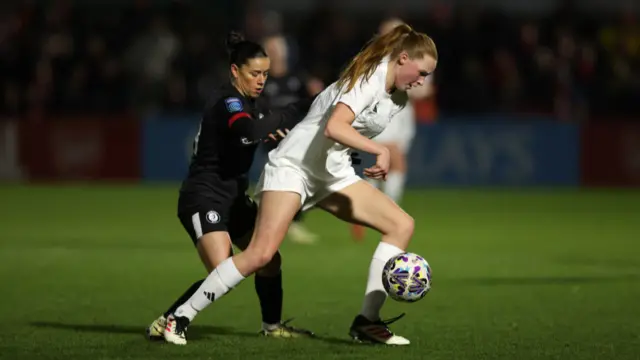 Katie Reid of Arsenal is challenged by Ffion Morgan of Bristol City during The Adobe Women's FA Cup Fourth Round match between Arsenal and Bristol City