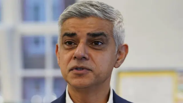 Sadiq Khan wearing a suit looking into camera with blurred background