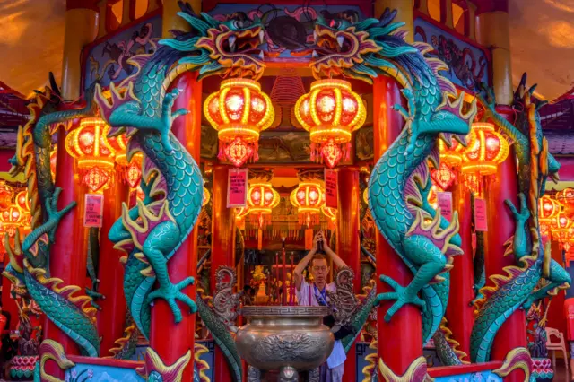 A man offers prayers at the Amurva Bhumi Vihara temple on the eve of the Lunar New Year of the Snake in Jakarta on January 28, 2025.