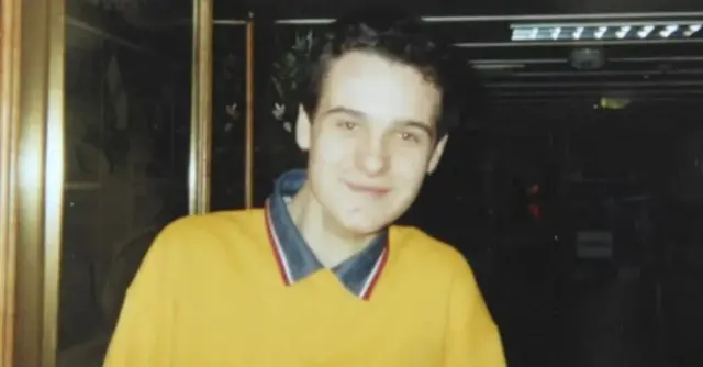 Alan Radford in yellow jumper with a blue shirt and brown hair