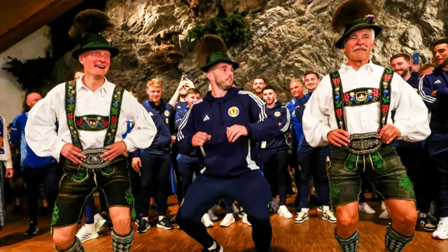 Scotland's John McGinn joins in a Bavarian dance during a welcome party in Garmisch-Partenkirchen, on June 09, 2024, in Garmisch-Partenkirchen, Germany.