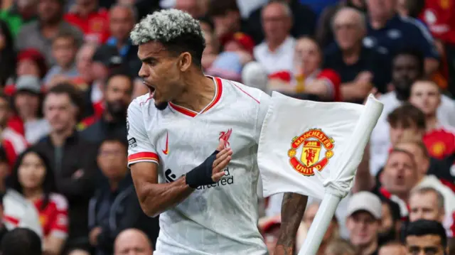 Liverpool's Luis Diaz celebrates with the corner flag at Old Trafford