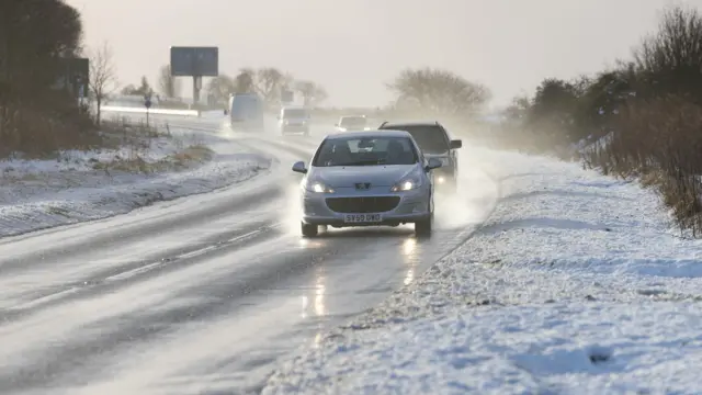 Vehicles drive on the A9 in Inverness, as snow, rain and wind warnings are in force before New Year's Eve