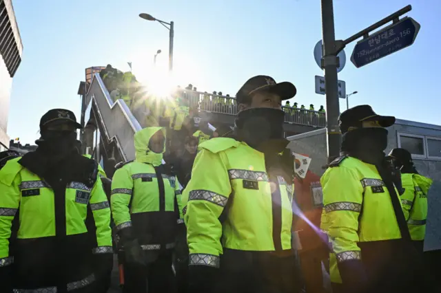 Police keep watch as supporters of South Korea's impeached President Yoon Suk Yeol gather near his residence in Seoul