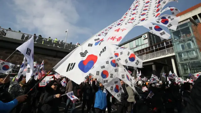 Protesters waving South Korean flags