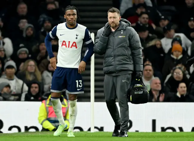 Destiny Udogie walking with the physio