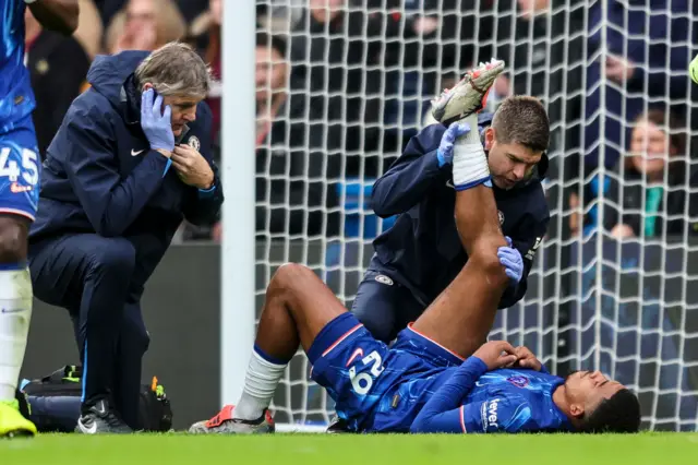 Wesley Fofana stretching his hamstring