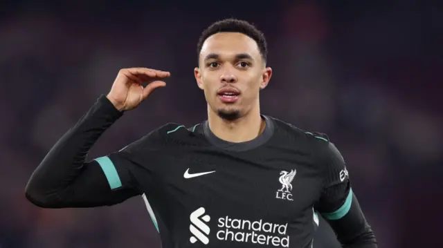 Liverpool's Trent Alexander-Arnold gestures with his hand after scoring against West Ham